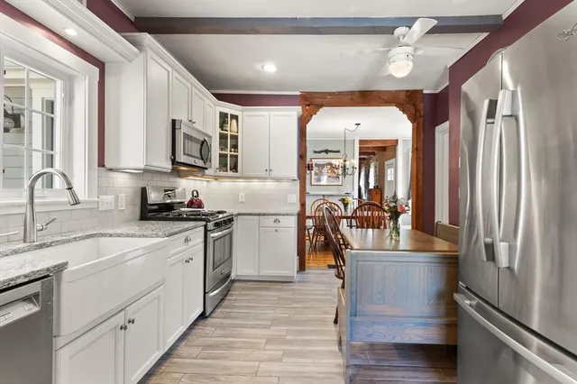a kitchen with stainless steel appliances granite countertop a refrigerator a stove and a sink