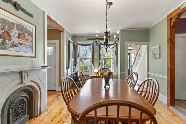 a view of a a dining room with furniture window and wooden floor