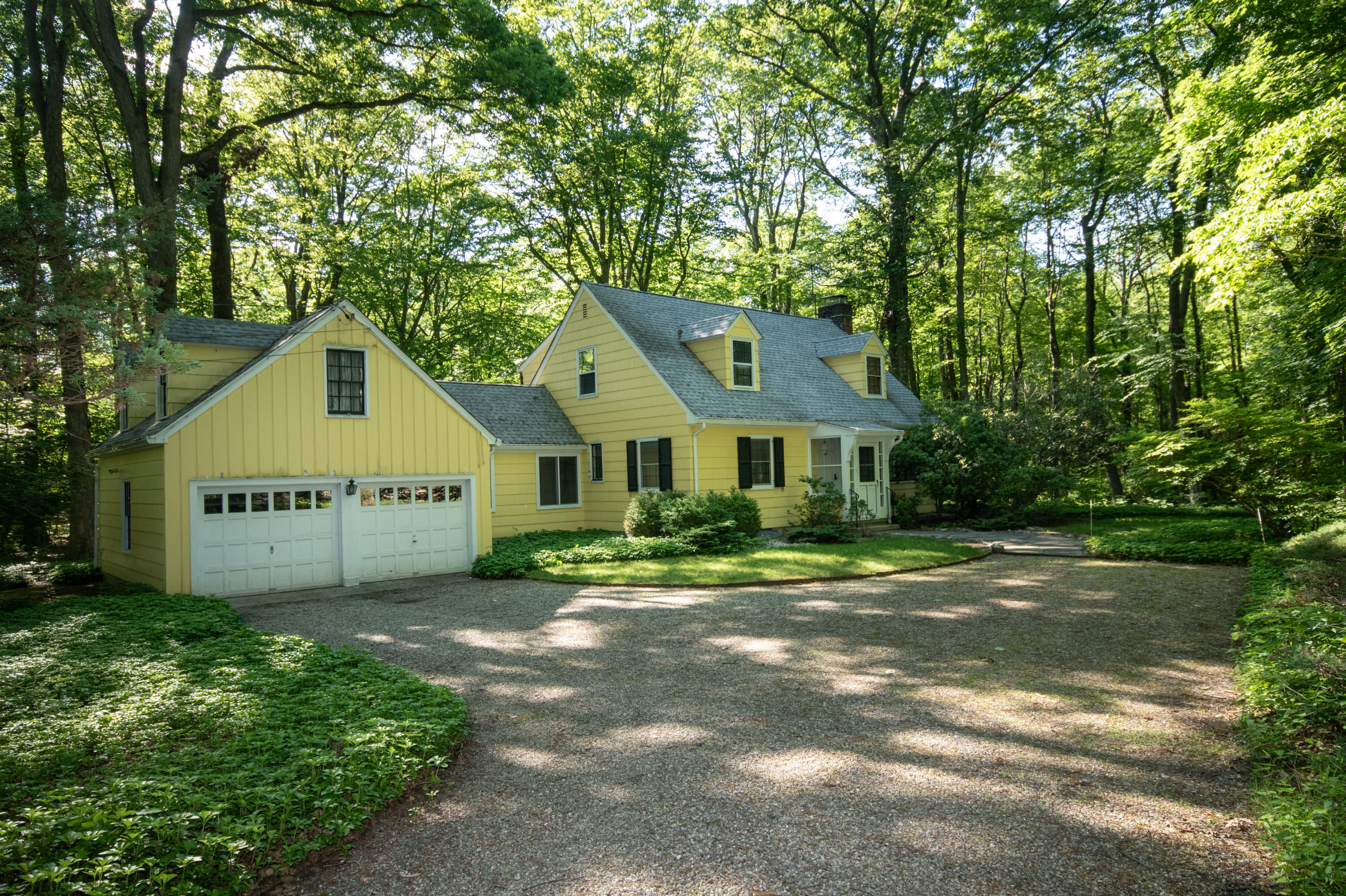 792 Smith Ridge Road New Canaan, CT 06840 - Photo 16 of 18 a front view of a house with a yard and garage