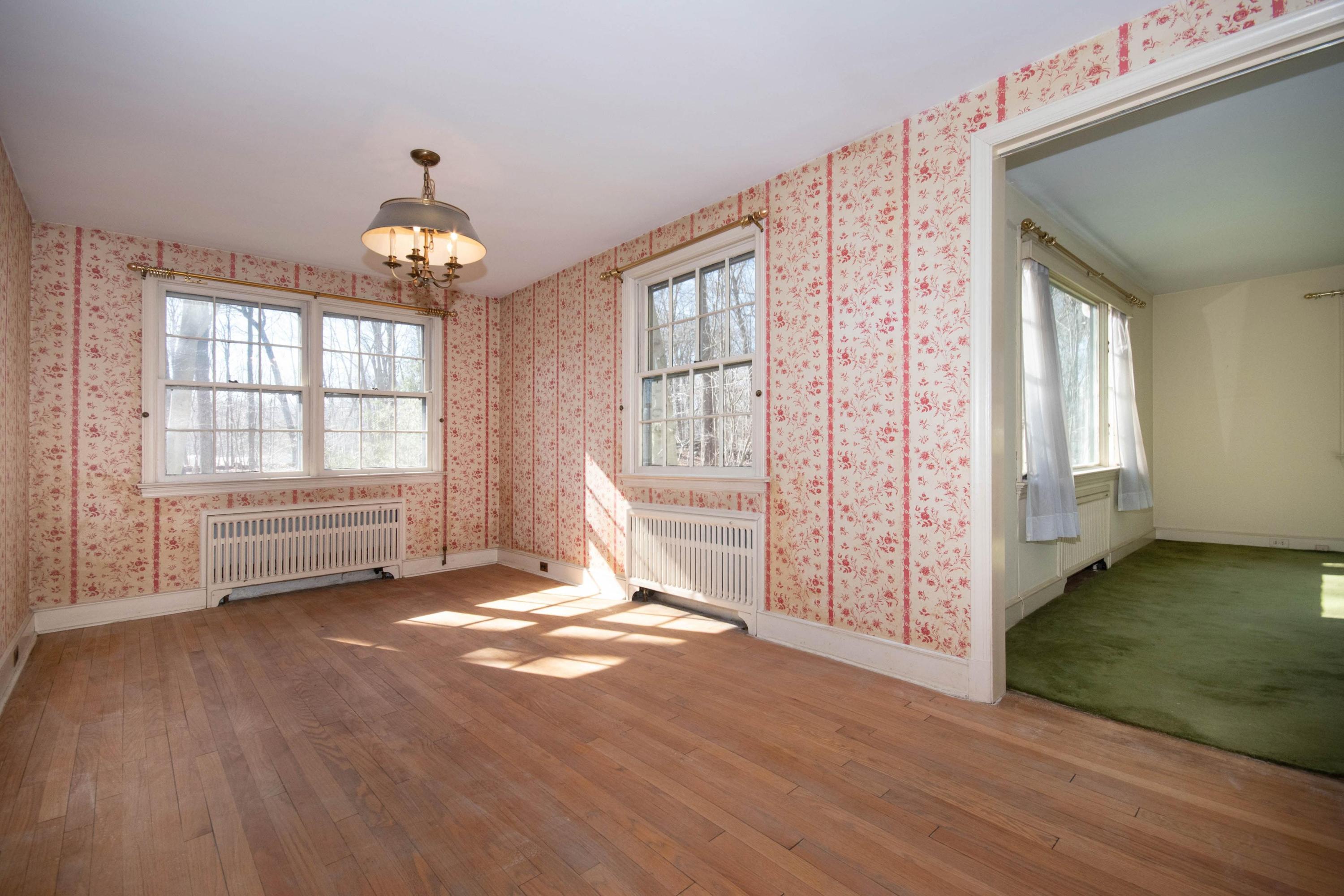 792 Smith Ridge Road New Canaan, CT 06840 - Photo 9 of 18 an empty room with wooden floor fan and windows