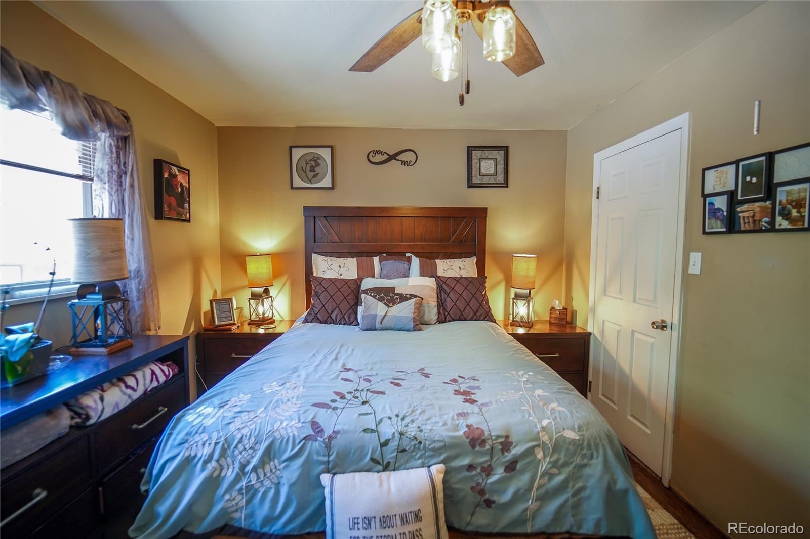 806 Paradise Lane Colorado Springs, CO 80904 - Photo 12 of 45 a bedroom with a bed and a chandelier