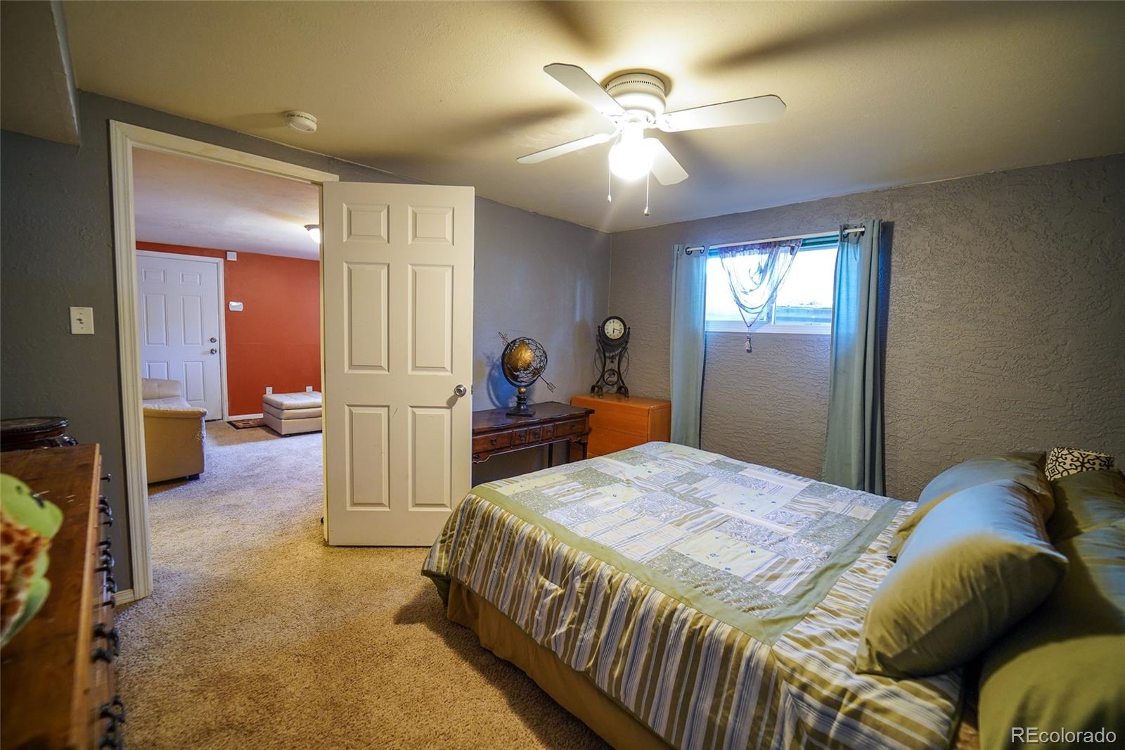 806 Paradise Lane Colorado Springs, CO 80904 - Photo 17 of 45 a spacious bedroom with a bed and a chandelier