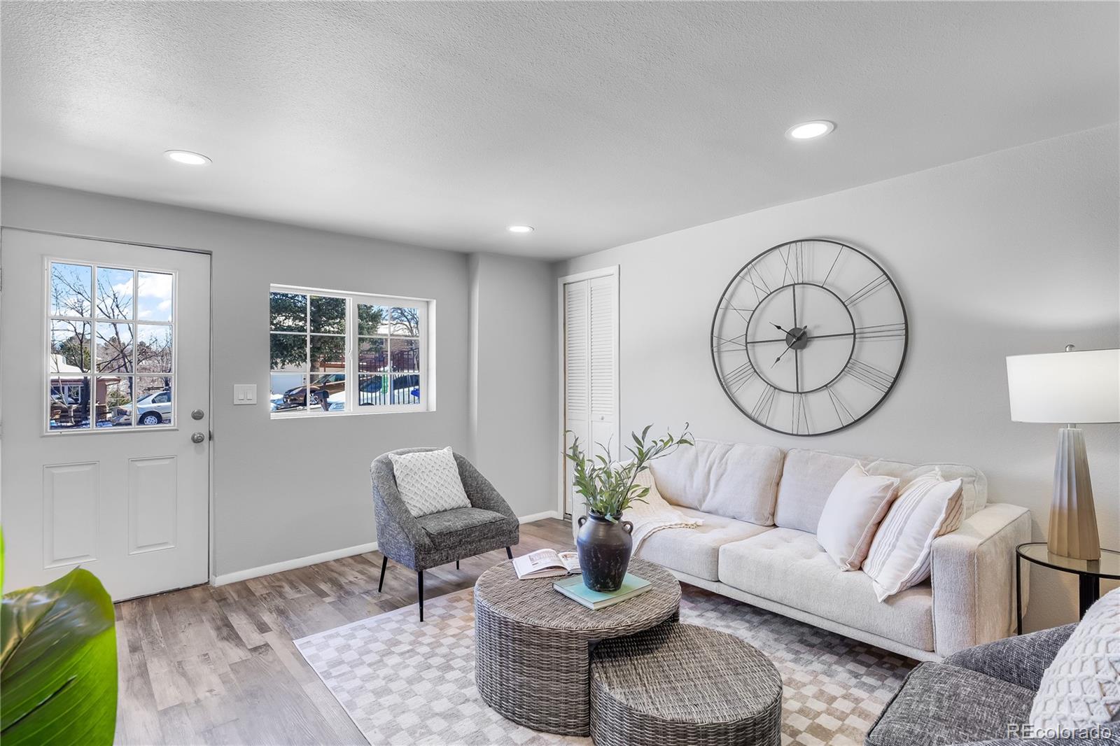 806 Paradise Lane Colorado Springs, CO 80904 - Photo 23 of 45 a living room with furniture a clock and a window