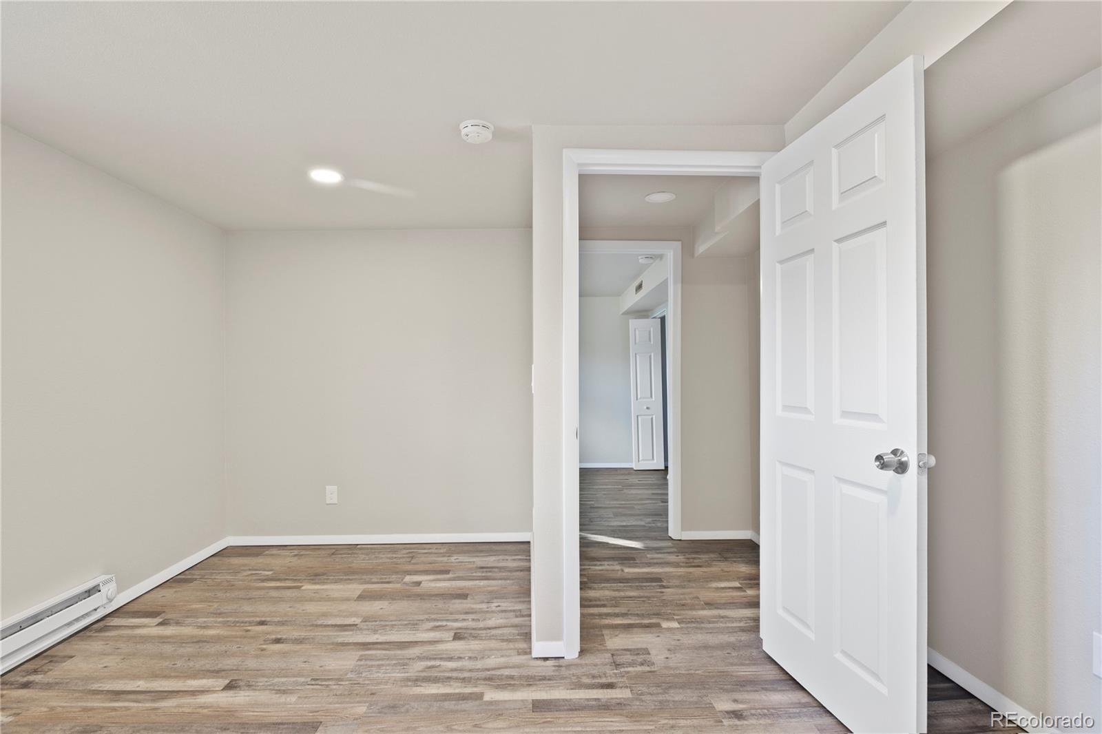 806 Paradise Lane Colorado Springs, CO 80904 - Photo 28 of 45 a view of a hallway with wooden floor
