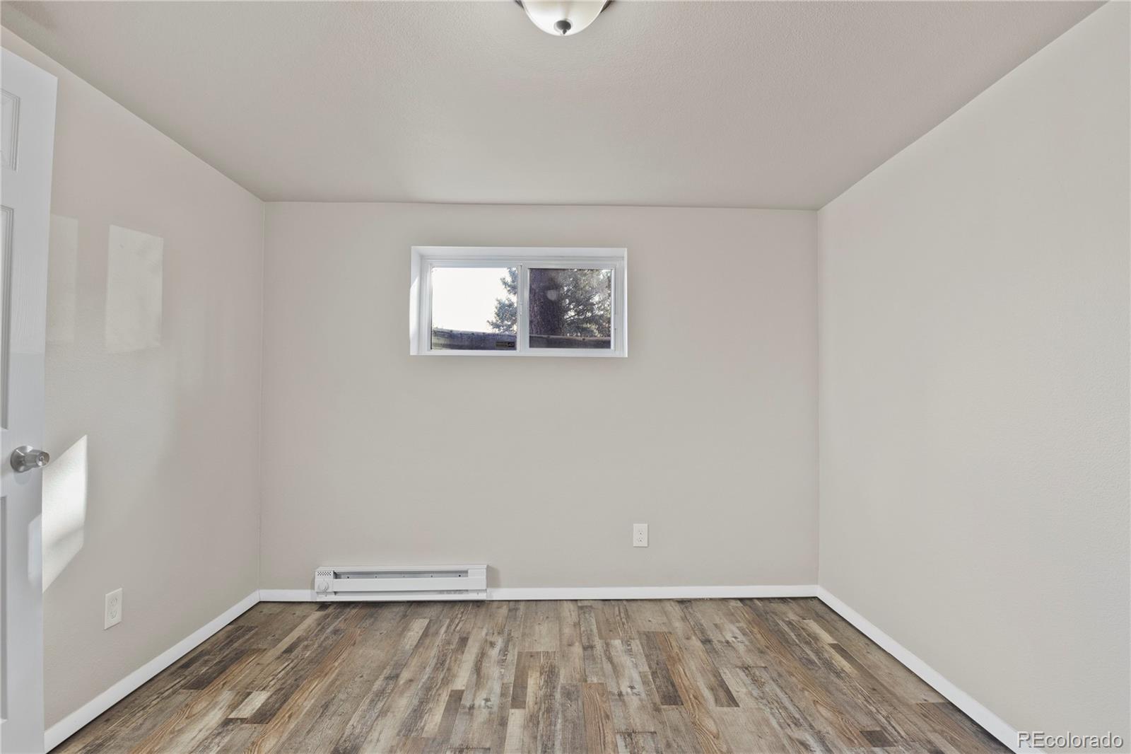 806 Paradise Lane Colorado Springs, CO 80904 - Photo 32 of 45 a view of room with window and hardwood floor