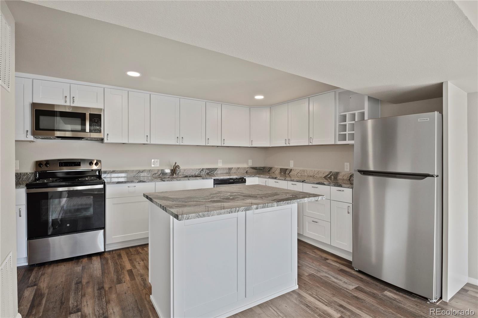 806 Paradise Lane Colorado Springs, CO 80904 - Photo 34 of 45 a kitchen with a sink stove and refrigerator