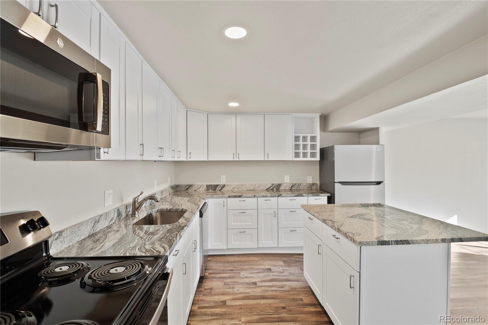 806 Paradise Lane Colorado Springs, CO 80904 - Photo 35 of 45 a kitchen with a stove and a sink