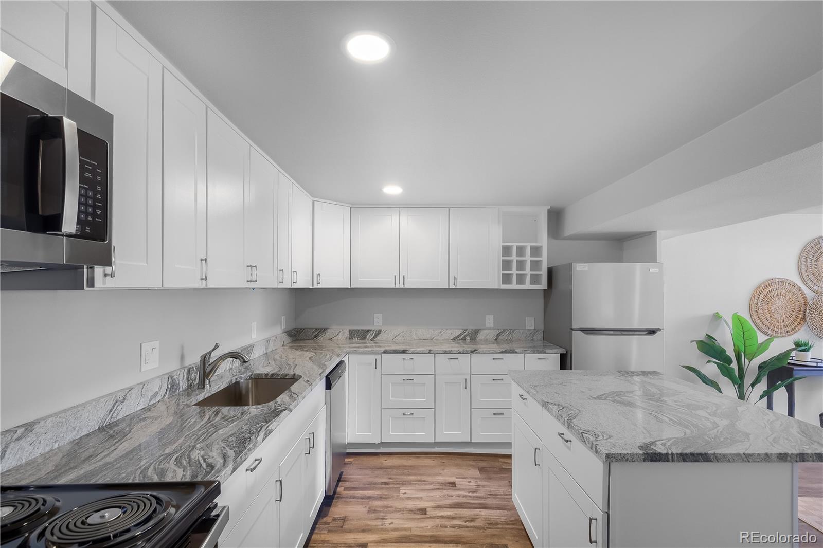806 Paradise Lane Colorado Springs, CO 80904 - Photo 36 of 45 a kitchen with granite countertop a sink a stove and a wooden cabinets