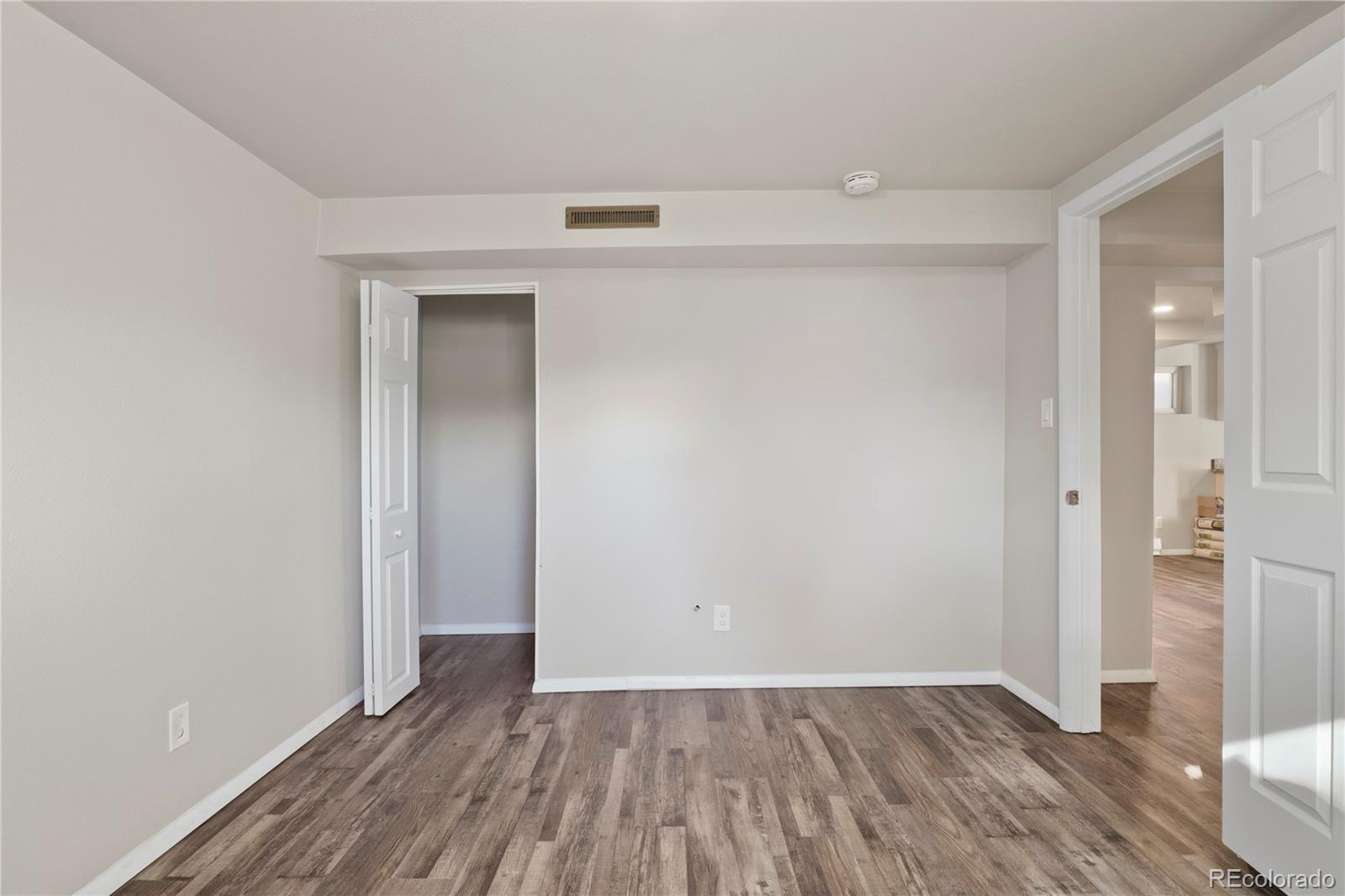 806 Paradise Lane Colorado Springs, CO 80904 - Photo 38 of 45 a view of an empty room with wooden floor