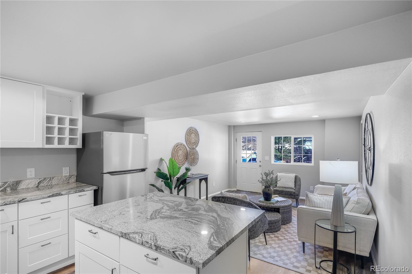 806 Paradise Lane Colorado Springs, CO 80904 - Photo 40 of 45 a kitchen with sink refrigerator and dining table