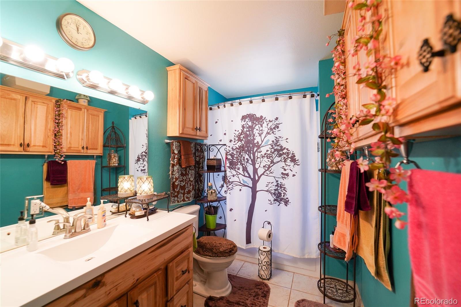 806 Paradise Lane Colorado Springs, CO 80904 - Photo 4 of 45 a bathroom with a sink vanity mirror and toilet