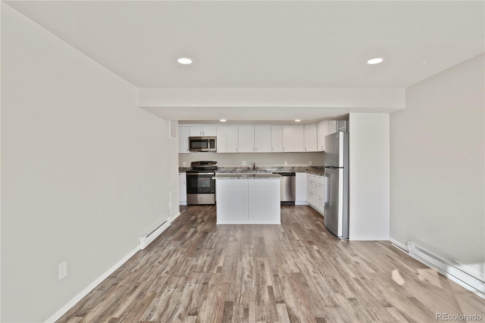 806 Paradise Lane Colorado Springs, CO 80904 - Photo 43 of 45 a kitchen with a refrigerator and white cabinets