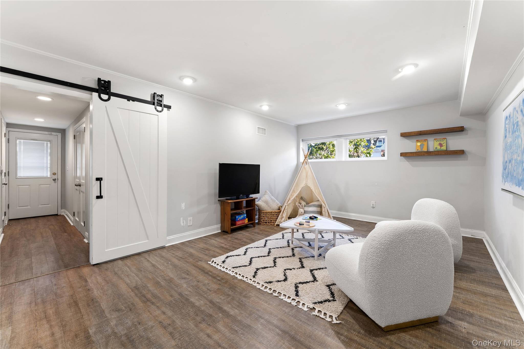 236 Robert Drive New Rochelle, NY 10804 - Photo 17 of 27 a living room with furniture and a flat screen tv