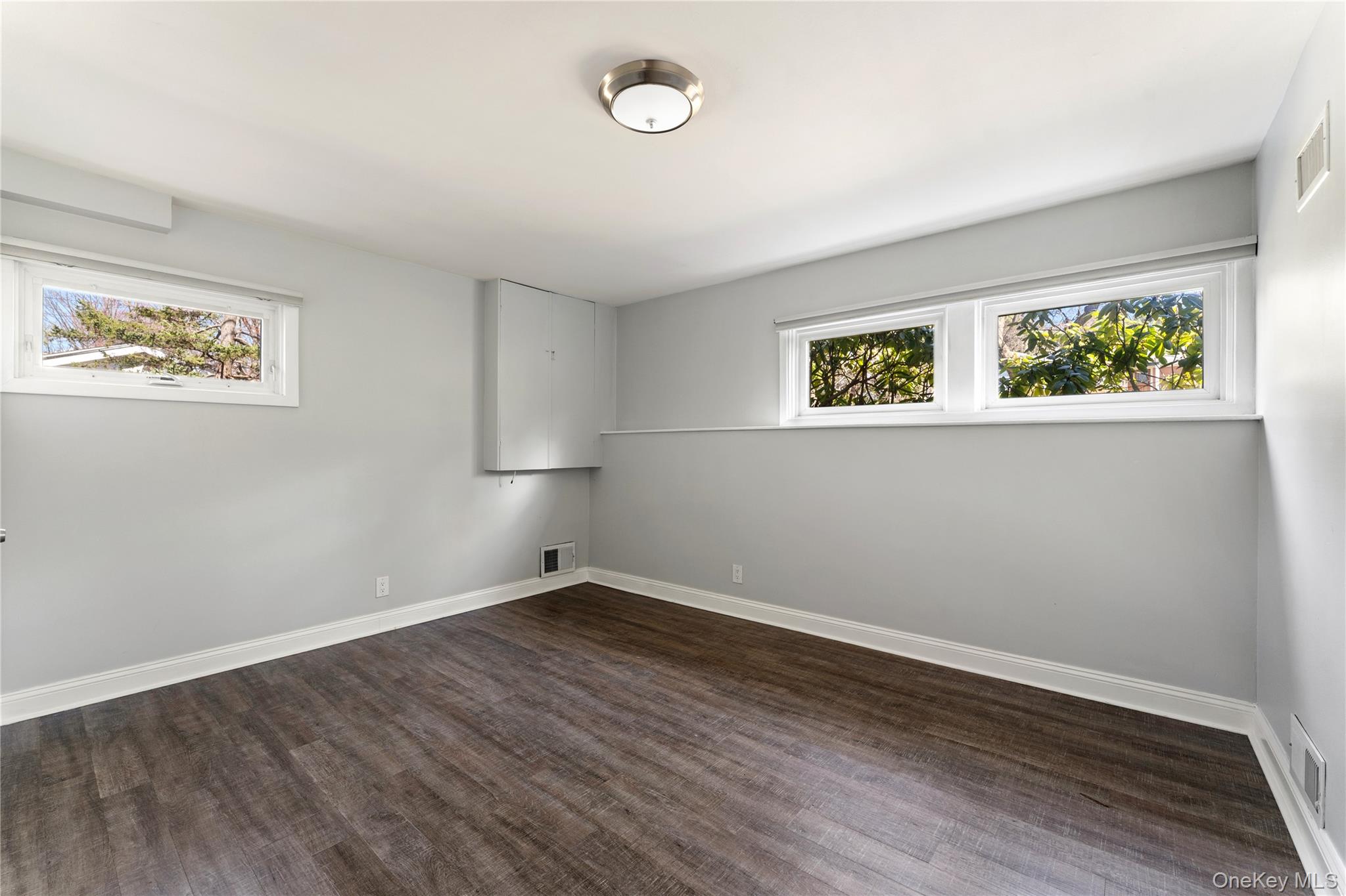 236 Robert Drive New Rochelle, NY 10804 - Photo 18 of 27 a view of an empty room with wooden floor and a window