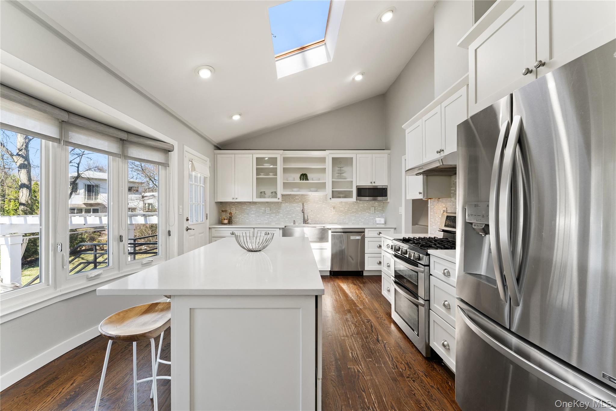236 Robert Drive New Rochelle, NY 10804 - Photo 7 of 27 a kitchen with stainless steel appliances a refrigerator a stove a sink dishwasher and microwave oven with wooden floor