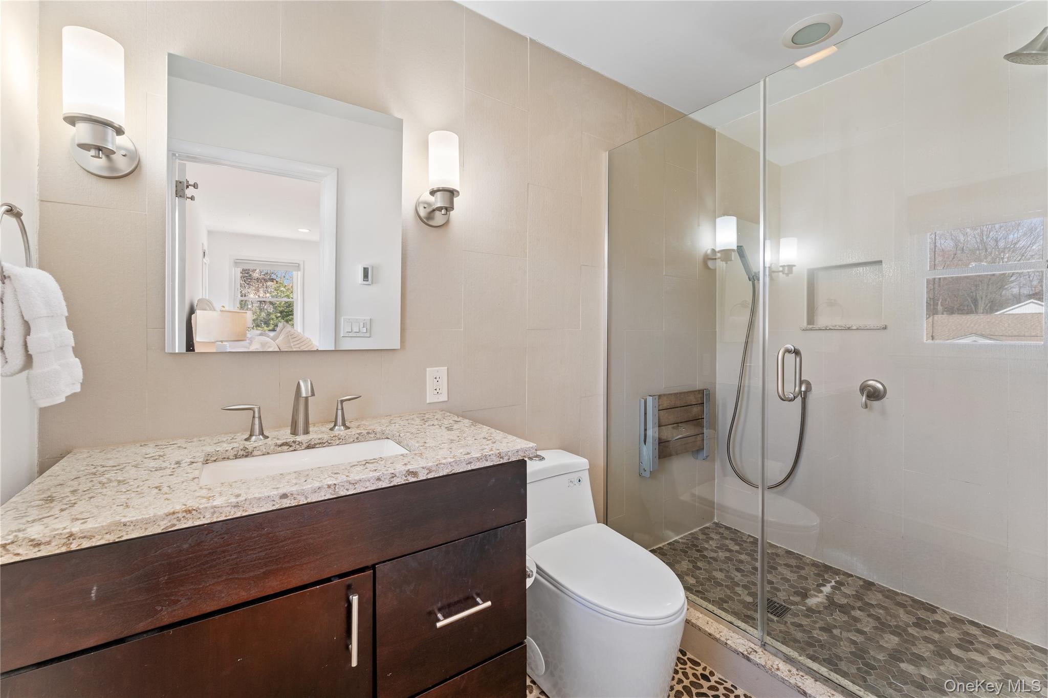 236 Robert Drive New Rochelle, NY 10804 - Photo 10 of 27 a bathroom with a granite countertop toilet sink and mirror