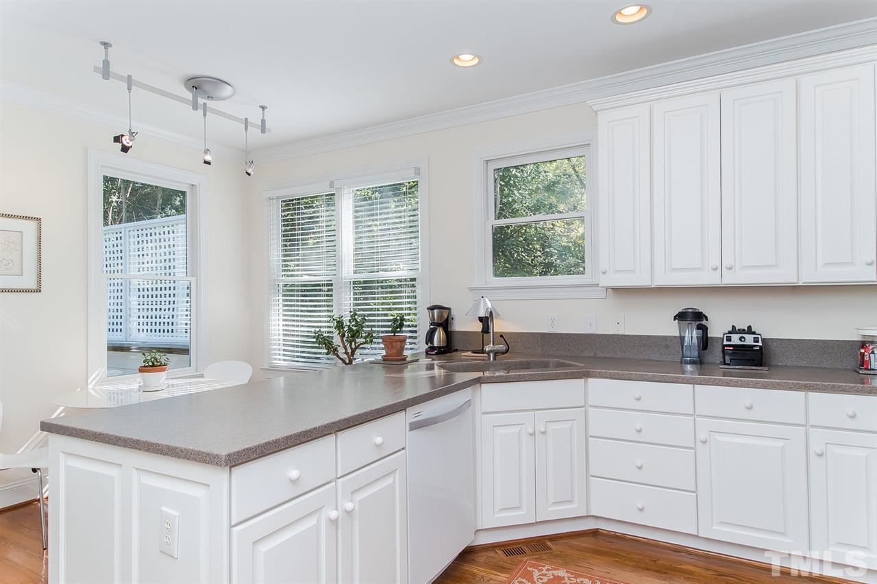 2712 Clark Avenue Raleigh, NC 27607 - Photo 8 of 24 a kitchen with granite countertop a sink and white cabinets