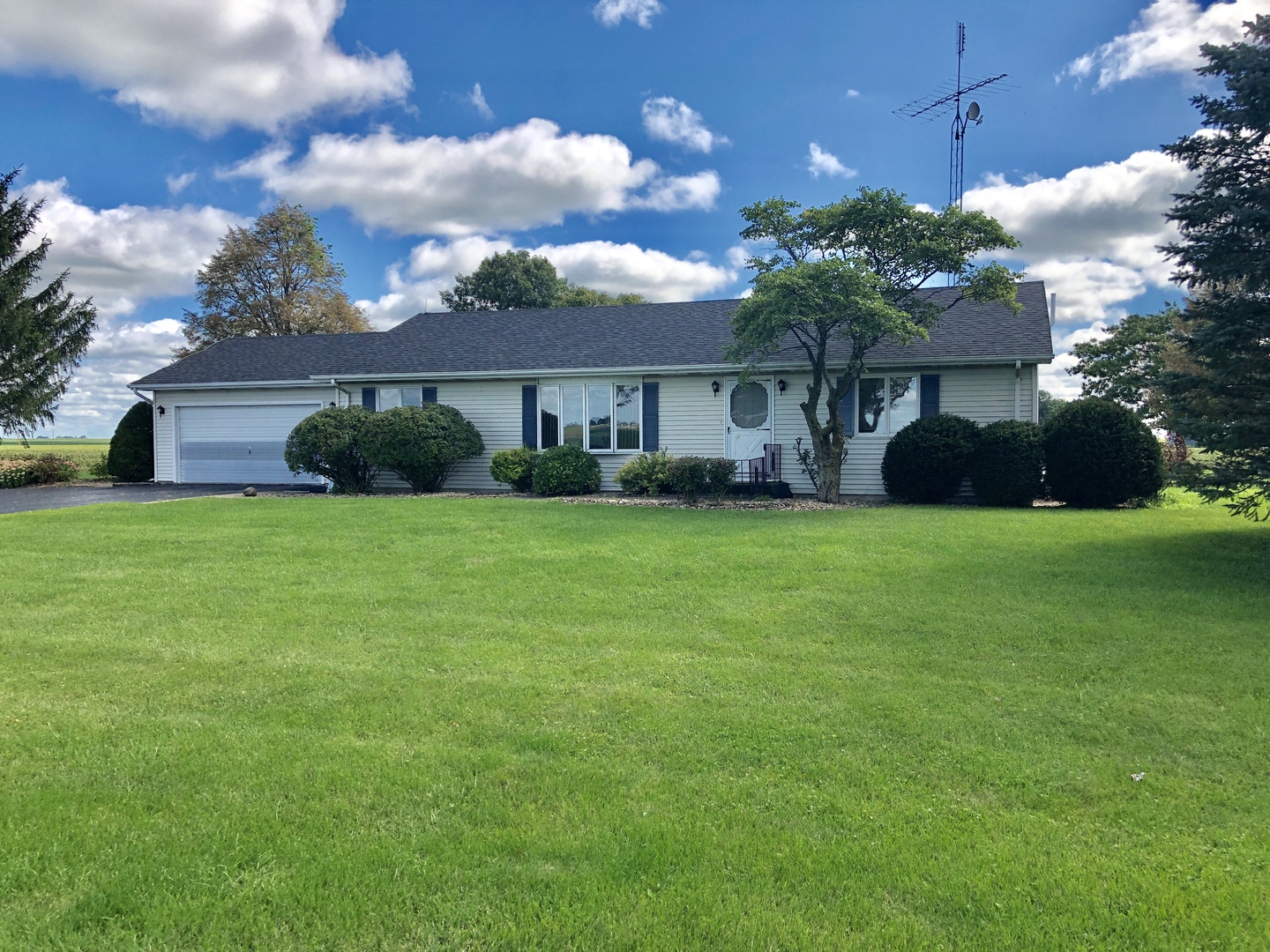 a view of a house with yard and a garden