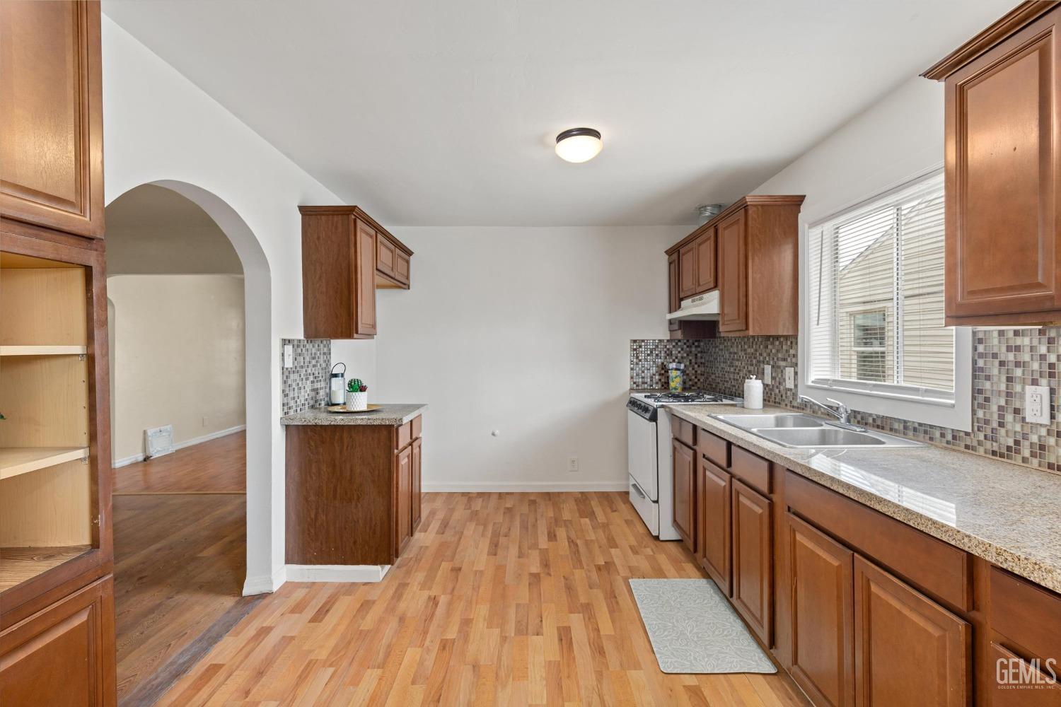 Undisclosed Address Bakersfield, CA 93308 - Photo 11 of 32 a kitchen with stainless steel appliances granite countertop a sink and wooden cabinets