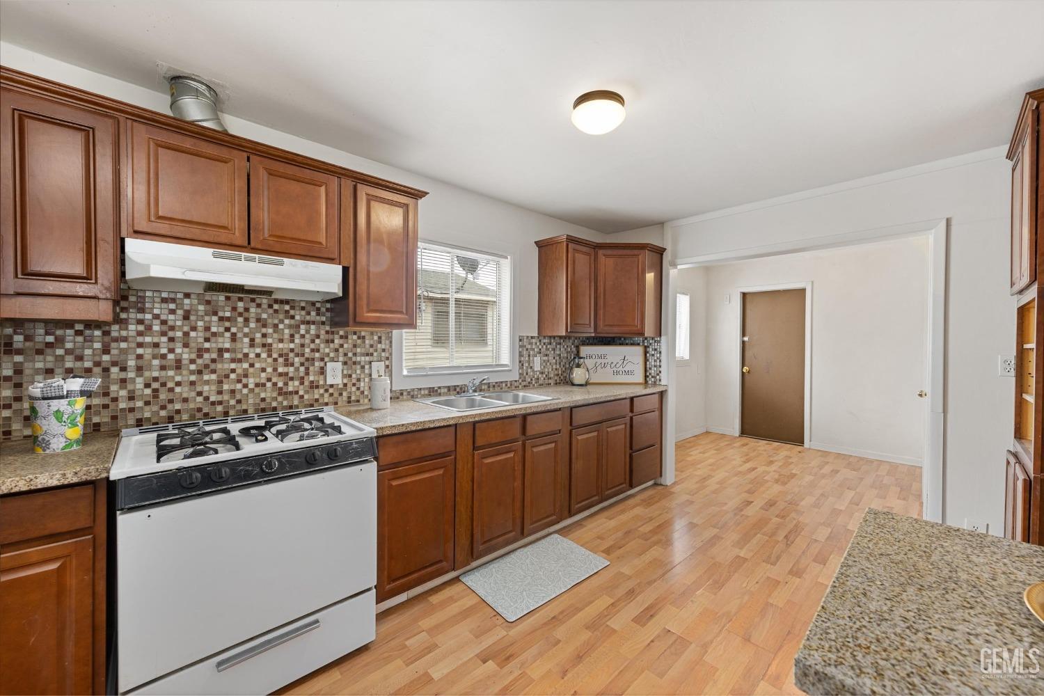 Undisclosed Address Bakersfield, CA 93308 - Photo 12 of 32 a kitchen with stainless steel appliances granite countertop a sink stove and refrigerator