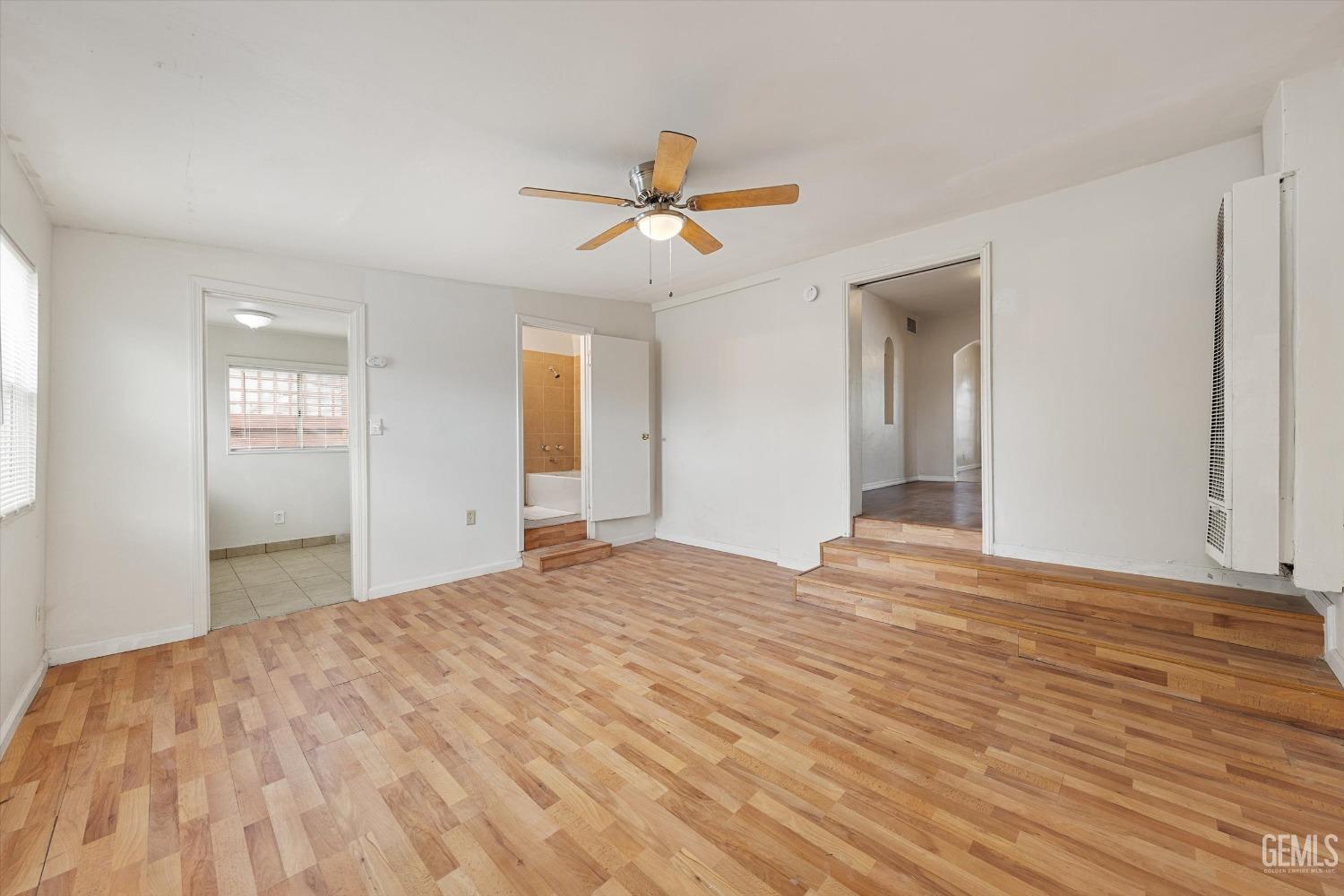 Undisclosed Address Bakersfield, CA 93308 - Photo 18 of 32 a view of empty room with wooden floor and fan