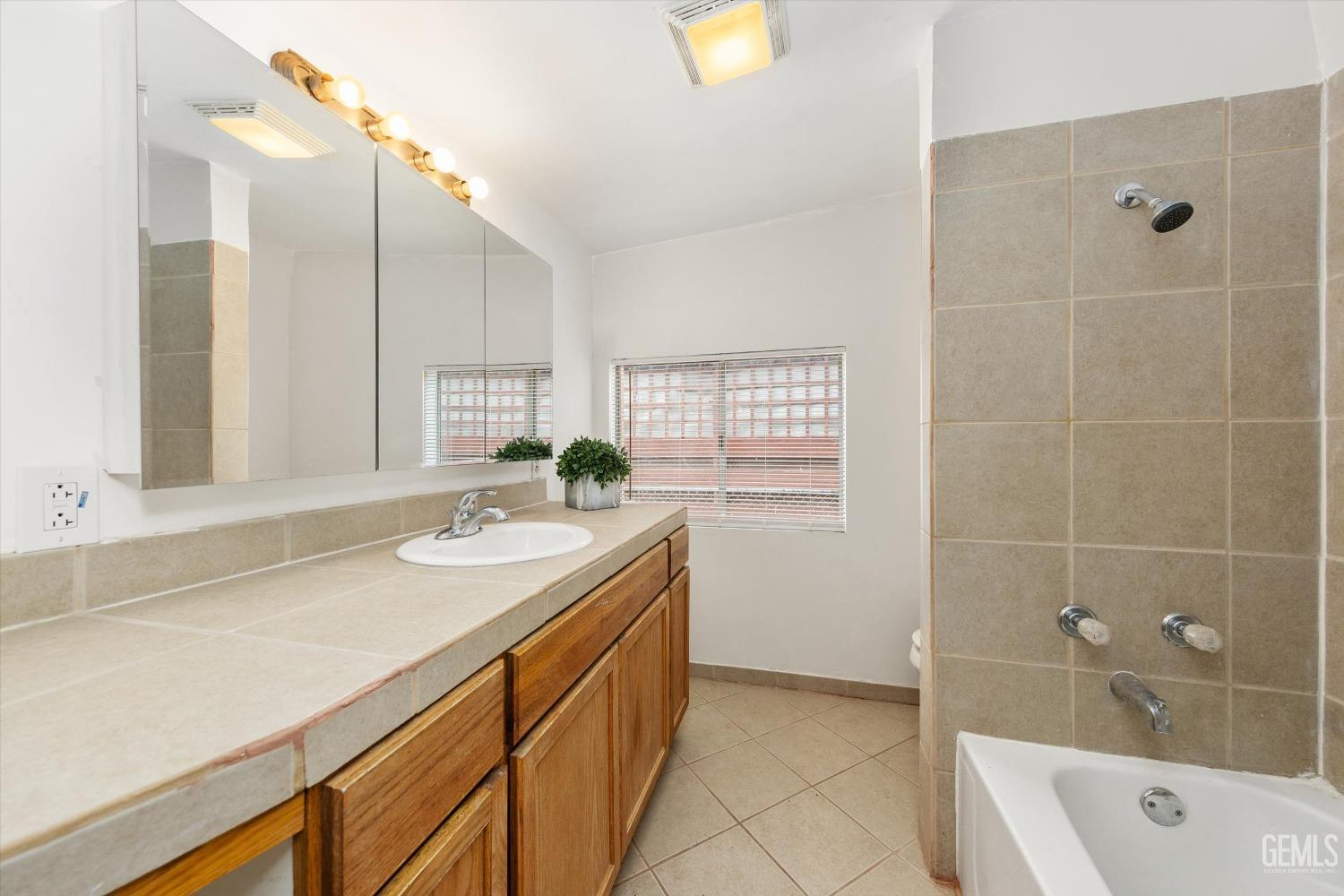 Undisclosed Address Bakersfield, CA 93308 - Photo 19 of 32 a bathroom with a granite countertop sink a toilet and shower