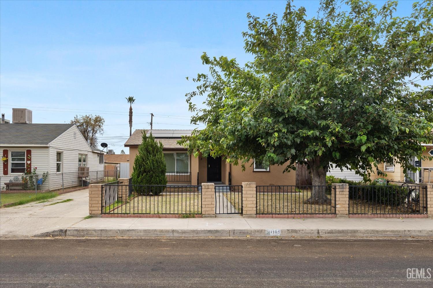 Undisclosed Address Bakersfield, CA 93308 - Photo 2 of 32 front view of a house with a small yard
