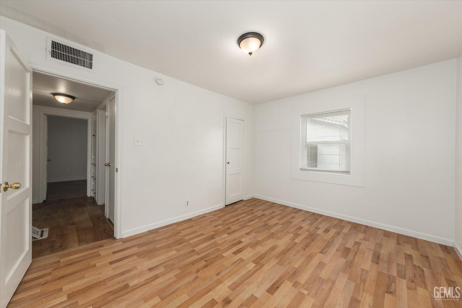 Undisclosed Address Bakersfield, CA 93308 - Photo 22 of 32 a view of empty room with wooden floor
