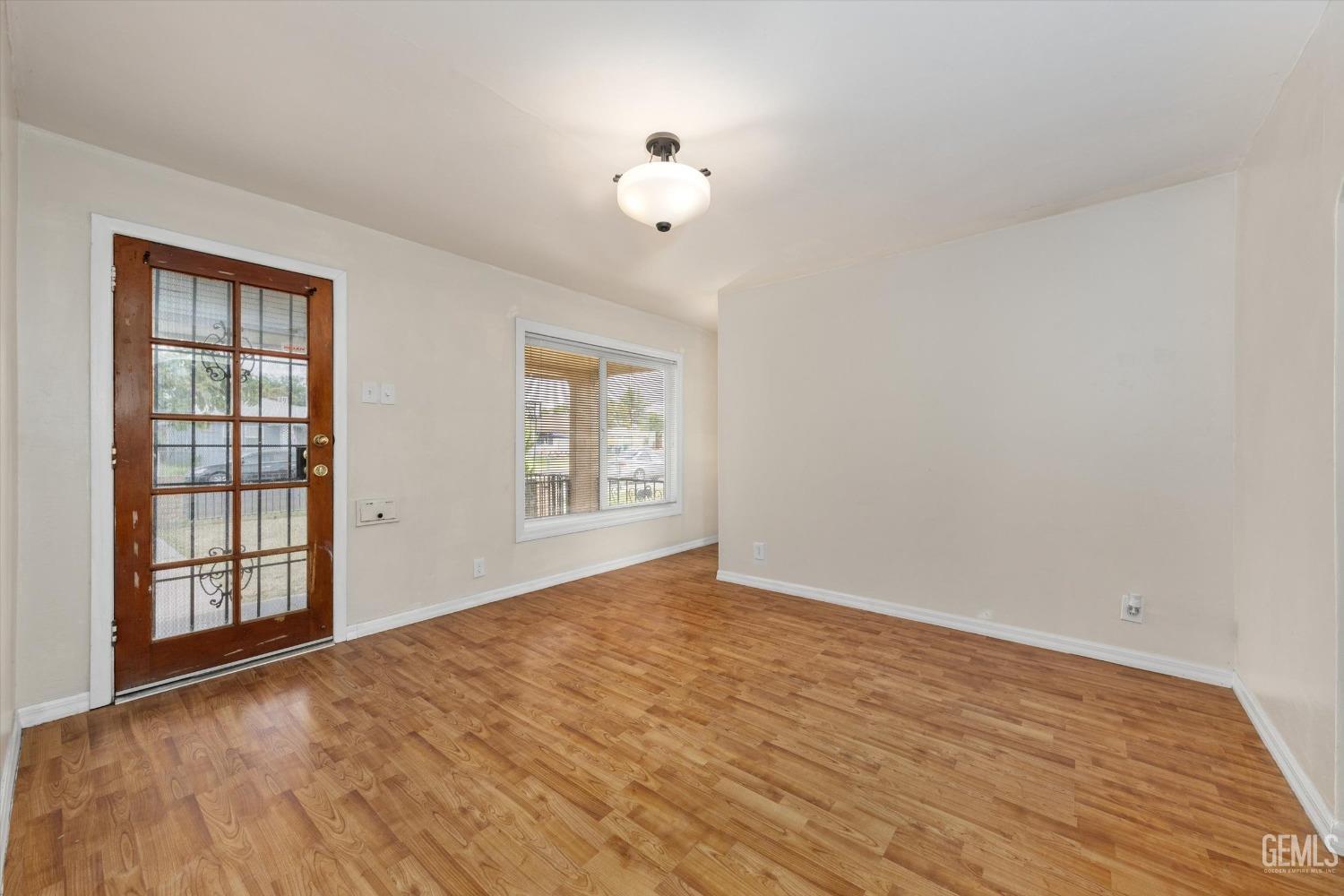 Undisclosed Address Bakersfield, CA 93308 - Photo 7 of 32 wooden floor in an empty room with a window