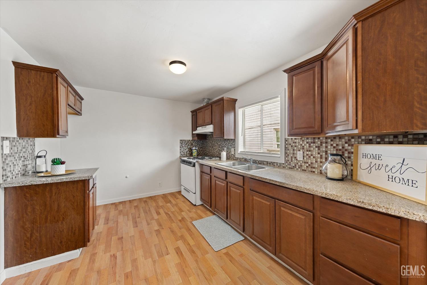 Undisclosed Address Bakersfield, CA 93308 - Photo 10 of 32 a kitchen with granite countertop stainless steel appliances a sink window and cabinets