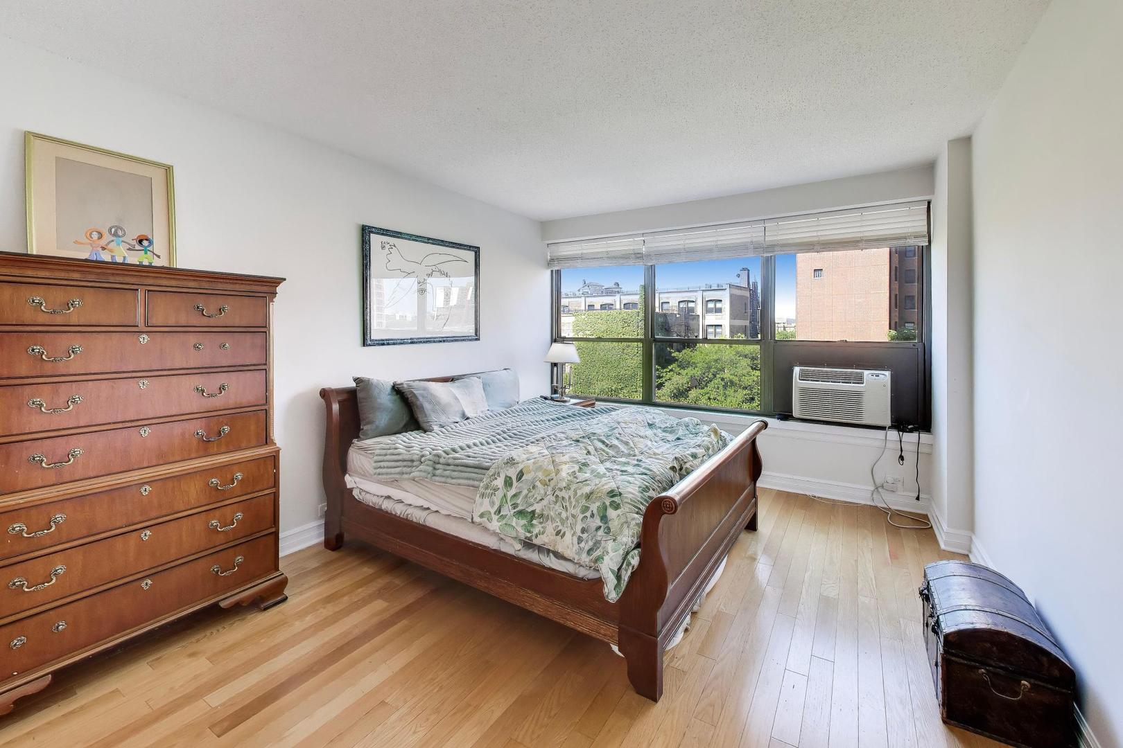 2930 North Sheridan Road, Unit 702 Chicago, IL 60657 - Photo 9 of 25 a bedroom with a bed and a dresser