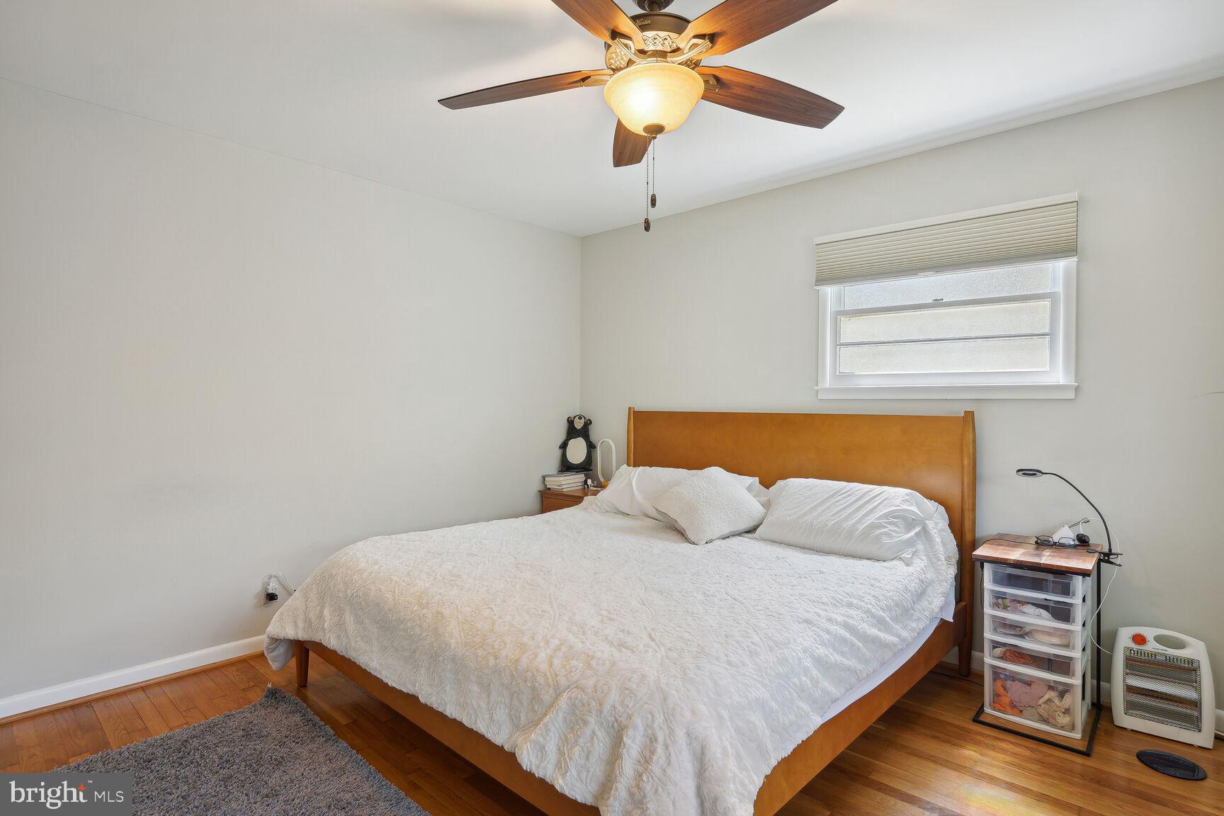 7011 Hector Road McLean, VA 22101 - Photo 10 of 20 a bedroom with a bed and a chandelier