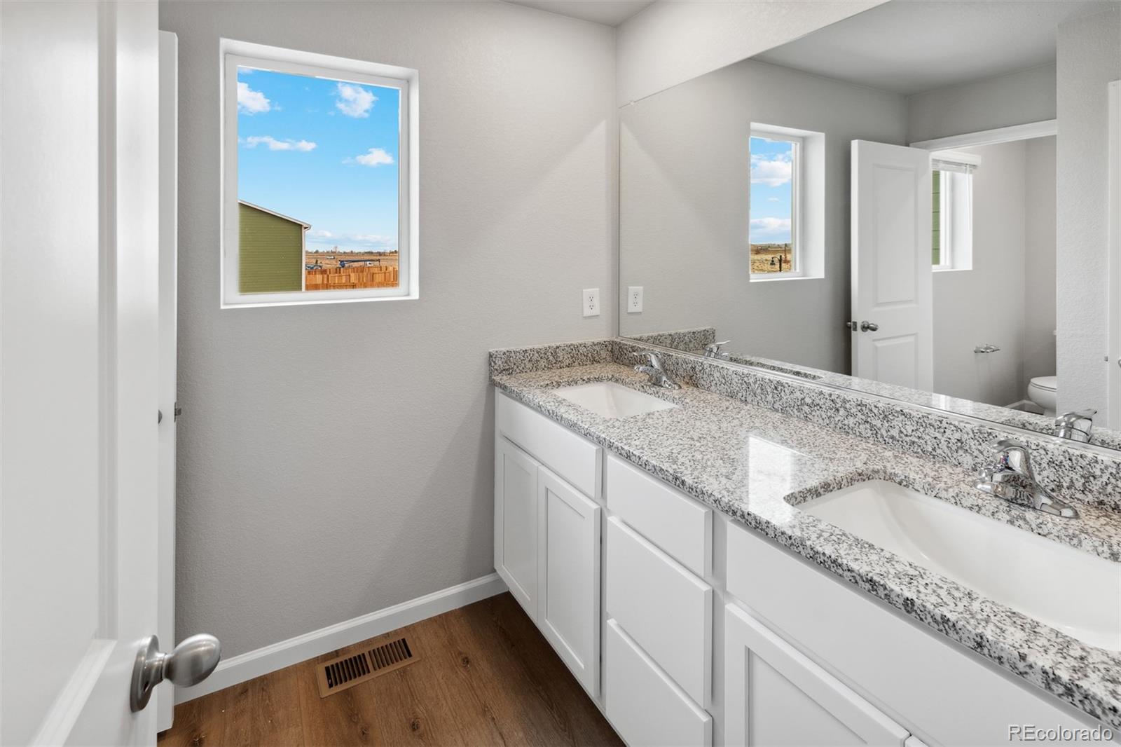 2160 Christina Street Fort Lupton, CO 80621 - Photo 18 of 41 a bathroom with a granite countertop sink and a mirror