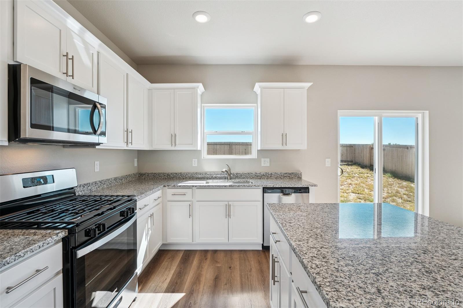 2160 Christina Street Fort Lupton, CO 80621 - Photo 3 of 41 a kitchen with stainless steel appliances granite countertop a stove and a sink