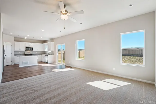 a view of kitchen with granite countertop cabinets and wooden floor