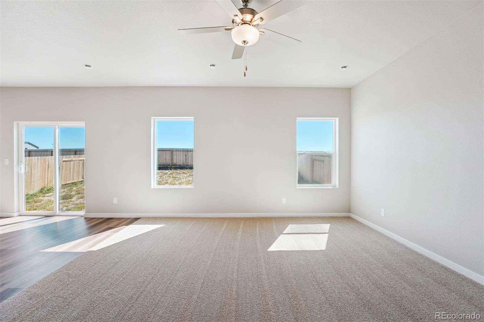 2160 Christina Street Fort Lupton, CO 80621 - Photo 7 of 41 wooden floor in an empty room with a window