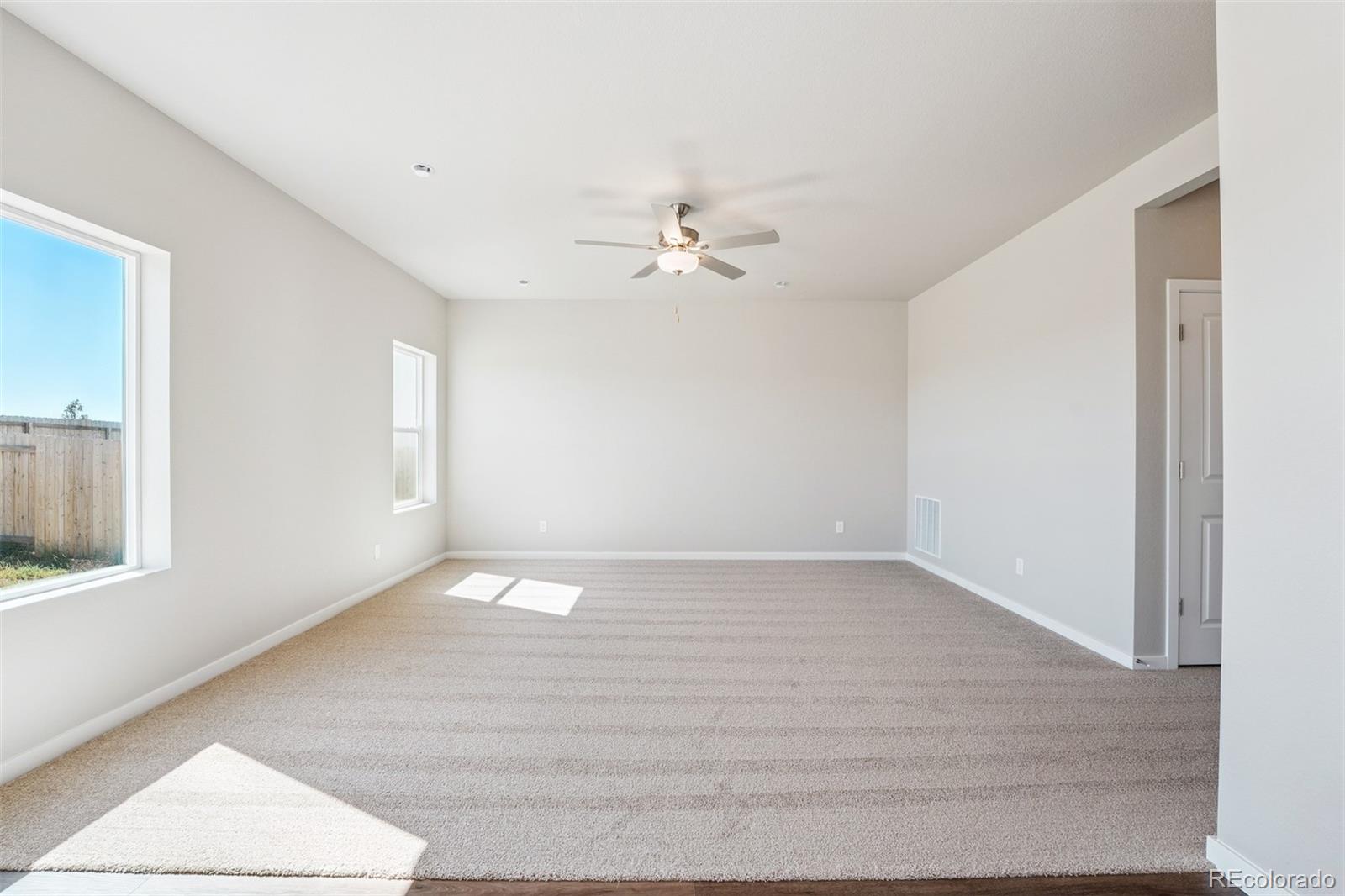 2160 Christina Street Fort Lupton, CO 80621 - Photo 8 of 41 a view of an empty room with a window