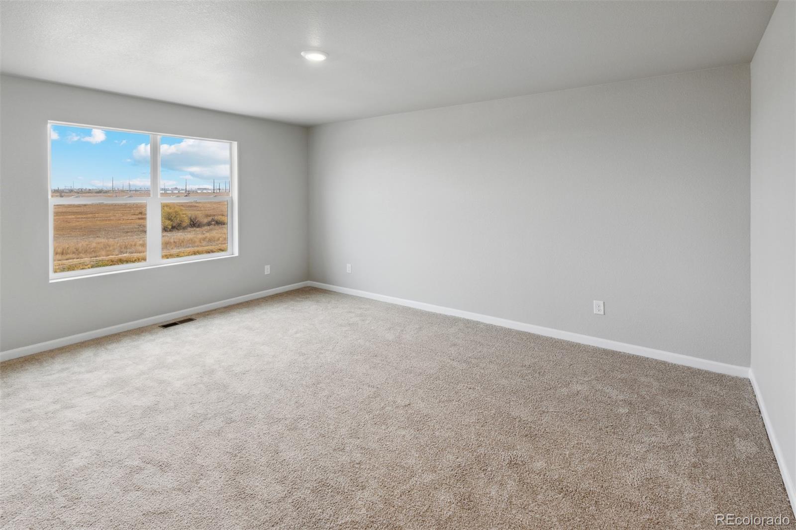 2160 Christina Street Fort Lupton, CO 80621 - Photo 10 of 41 an empty room with a window