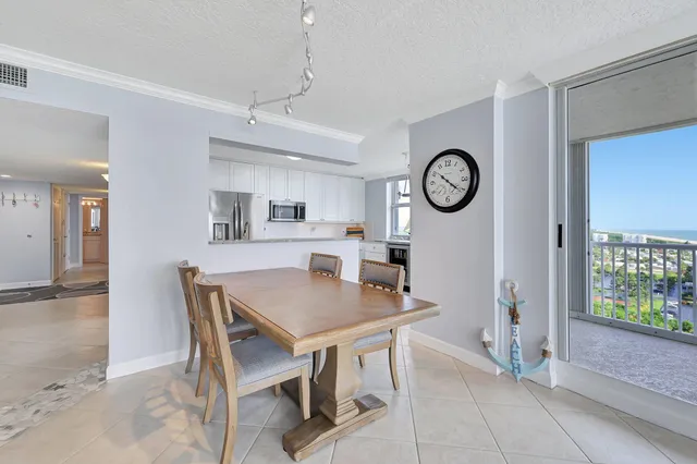 a living room with furniture a flat screen tv and a large window