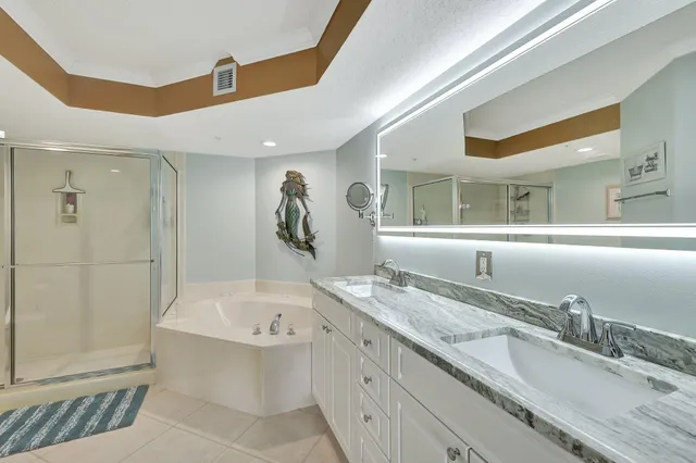a living room with furniture a chandelier fan and a window