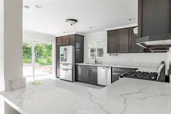 a kitchen with a stove a refrigerator and a sink
