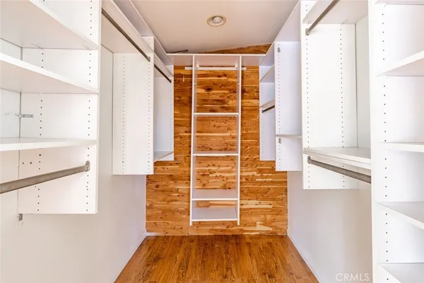 a view of walk in closet with empty racks