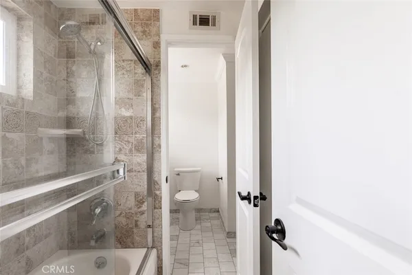 a bathroom with a glass shower door
