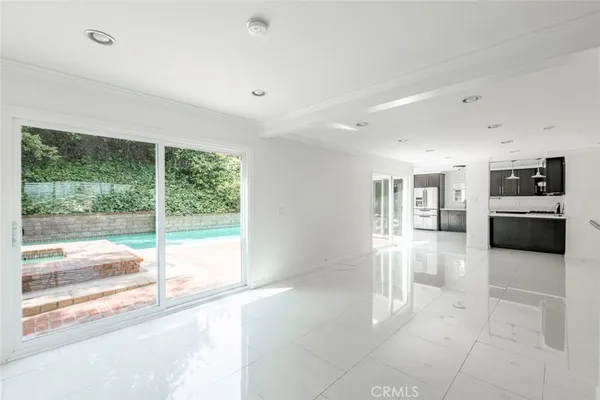 a view of a kitchen with a sink and a large window
