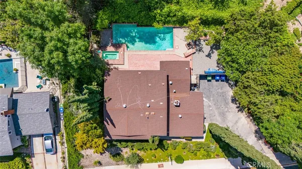 an aerial view of a house with yard and green space