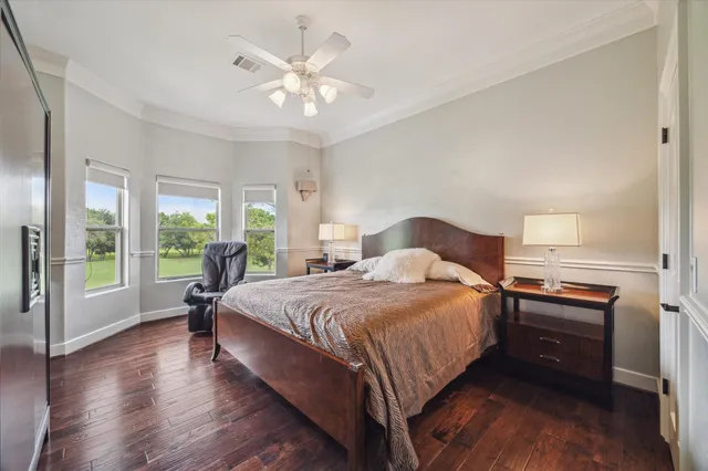 a bed sitting in a spacious bedroom next to a window