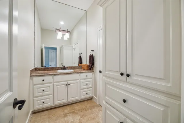 a bathroom with a double vanity sink mirror and toilet