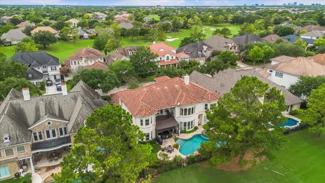 an aerial view of residential house with outdoor space and swimming pool