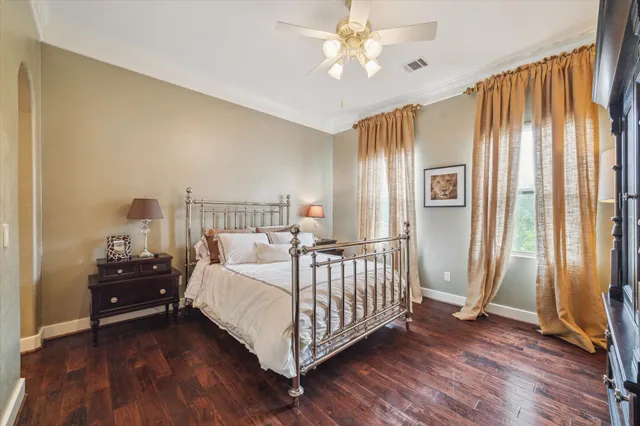 a bedroom with a bed wooden floor and window