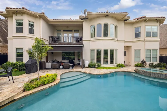 a view of a swimming pool with a patio